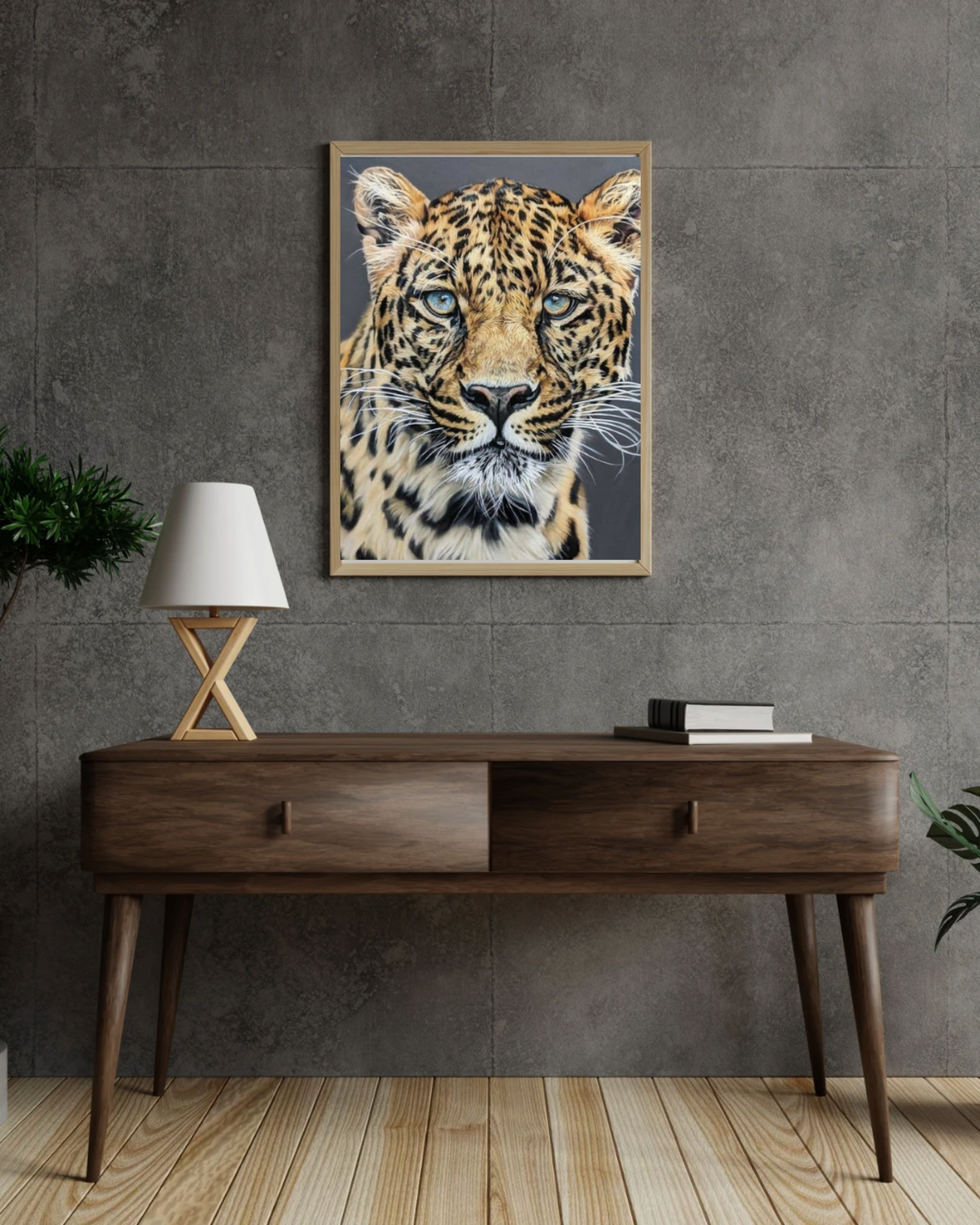 Framed artwork of a leopard on a wall above a wooden console table.
