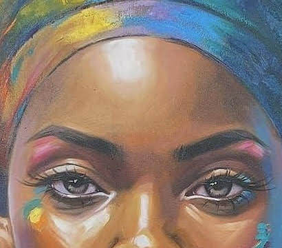 Close-up of a person's face with colorful headscarf and makeup