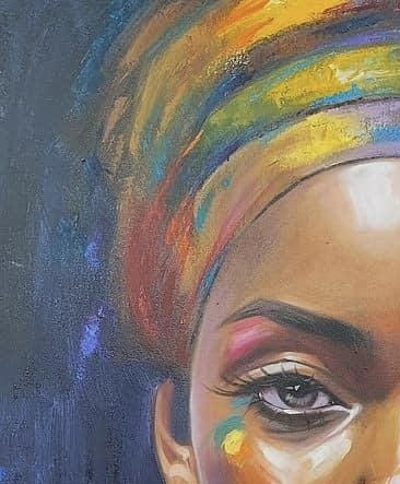 Close-up of a person's face with colorful headscarf and eye makeup